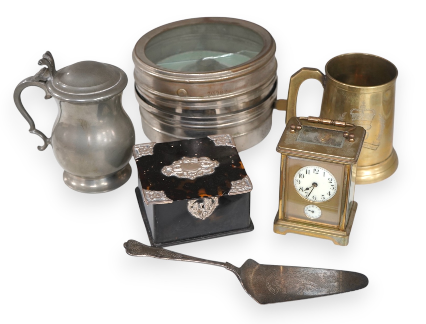 A small collection of metalware to include a white metal mounted tortoiseshell box, brass cased carriage clock with subsidiary dial and a pewter tankard. Condition - poor to fair